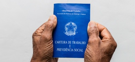 Hands black senior man holding work book brazilian social security document